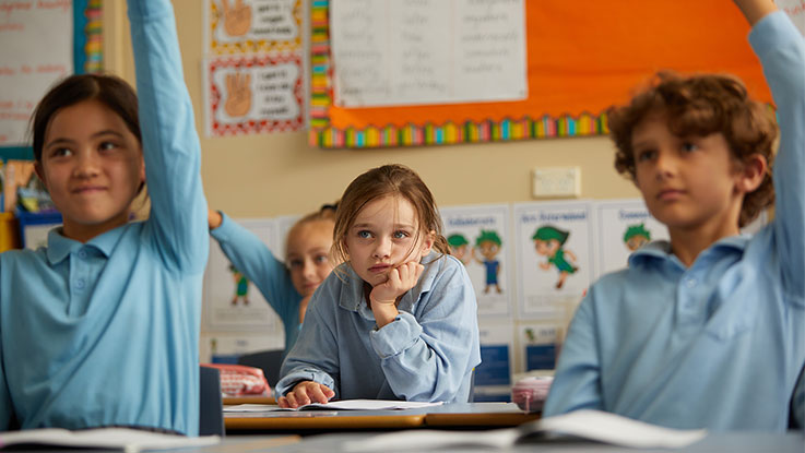 Sarah sitting at desk in classroom