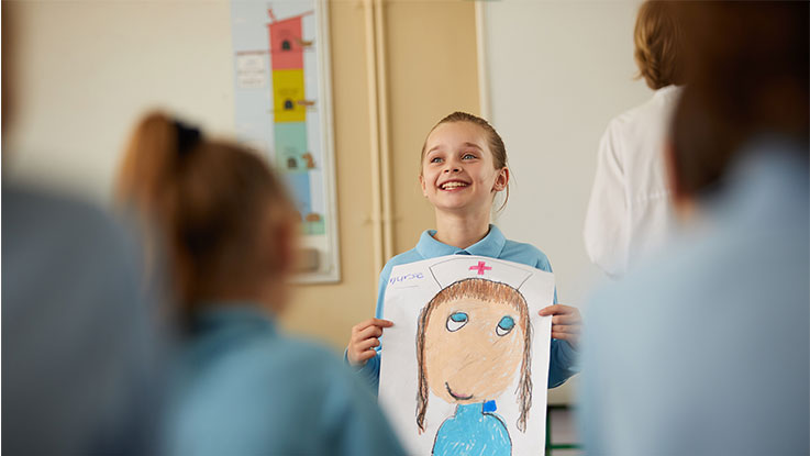 Sarah presenting picture in classroom