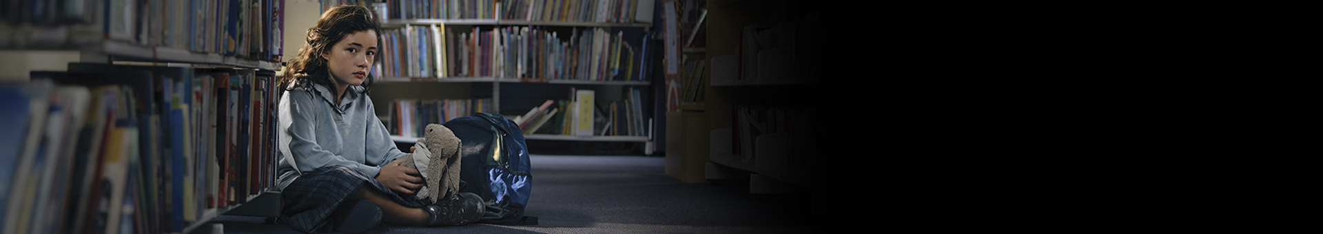 Lucy sitting on floor in library