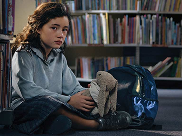 Lucy sitting in library floor