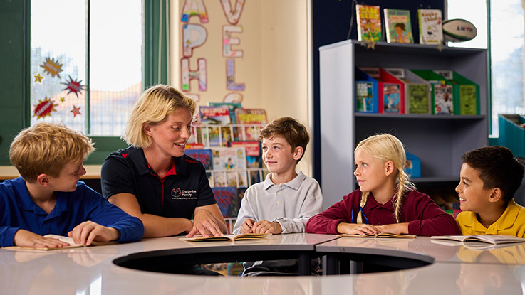 a smith family learning club coordinator with students in a classroom