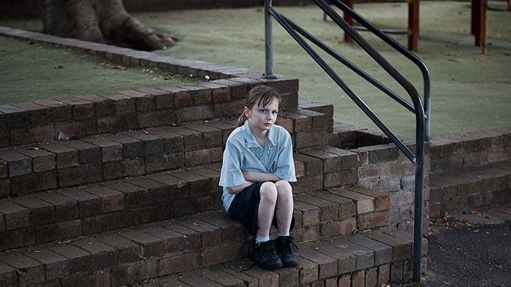 Girl sitting on school steps