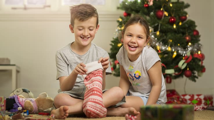 Two kids opening Christmas presents
