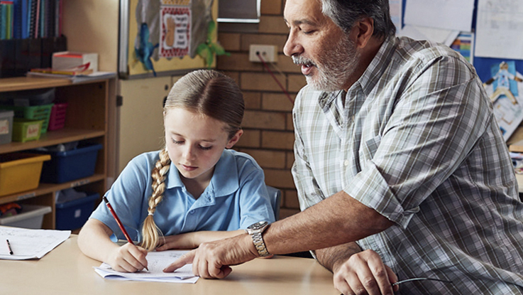 Child sitting at table with adult