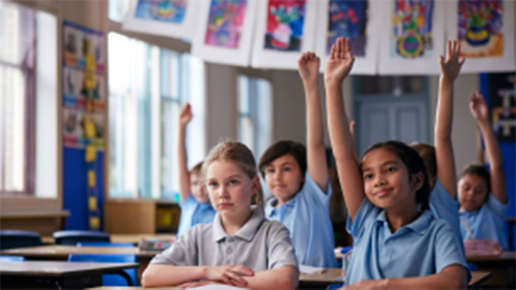 Ruby sitting at a desk in a classroom