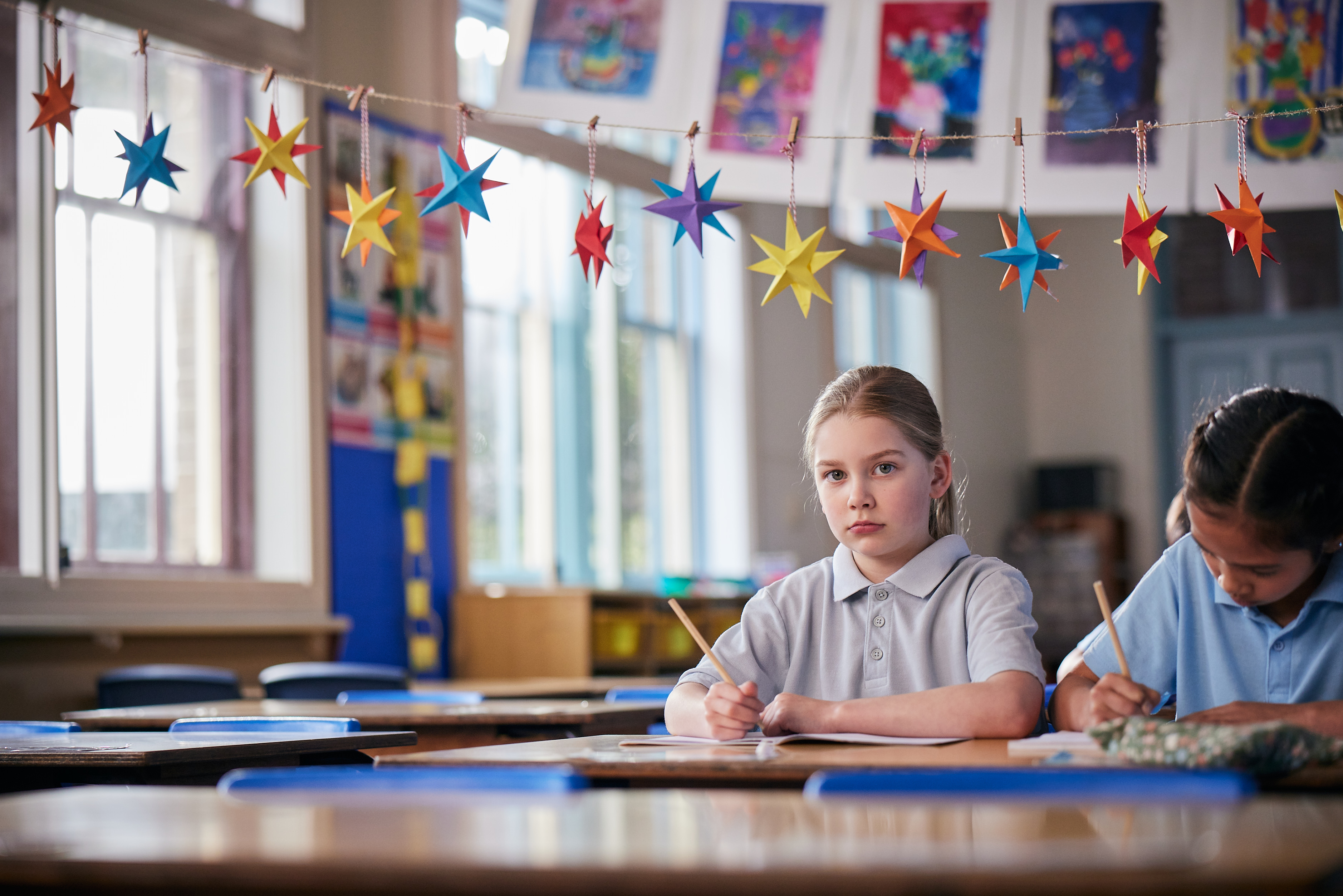 Students completing classwork in a primary school classroom.