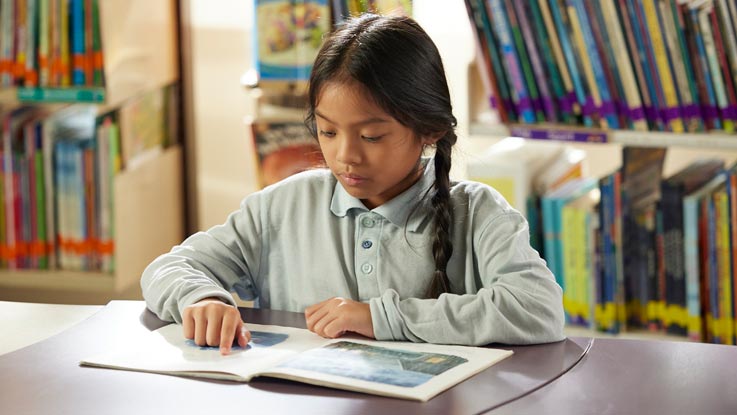 Girl reading in classroom