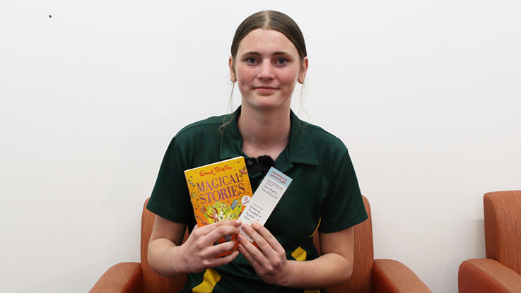a school teen holding a book and a bookmark