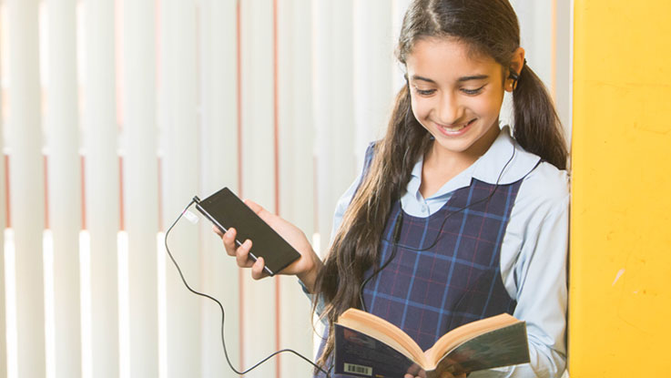 Girl with book headphones