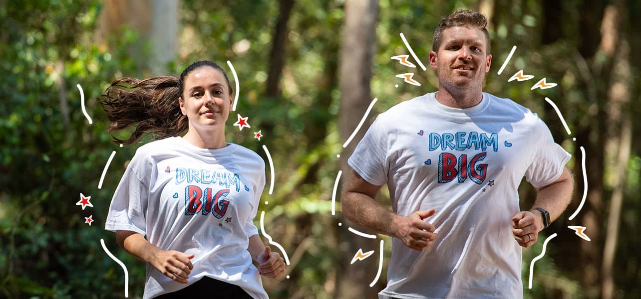 two people running for charity with dream big on their tshirts