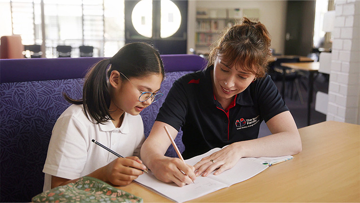 student and tutor learning and working on school-work