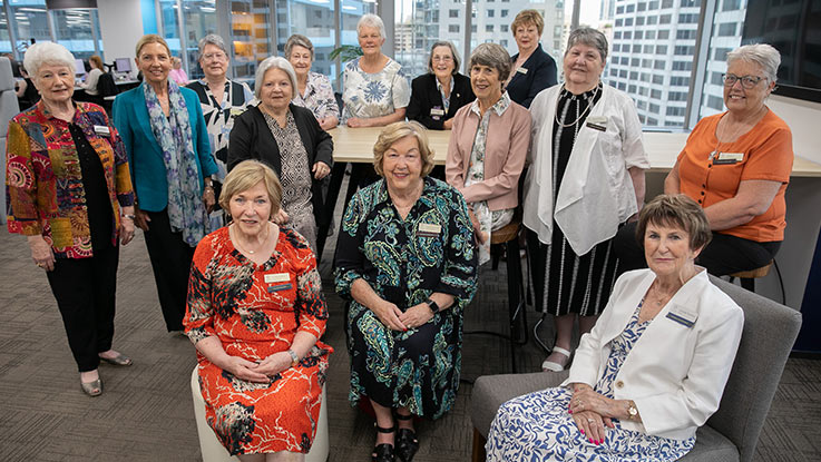 a group of ladies sitting together in an office space