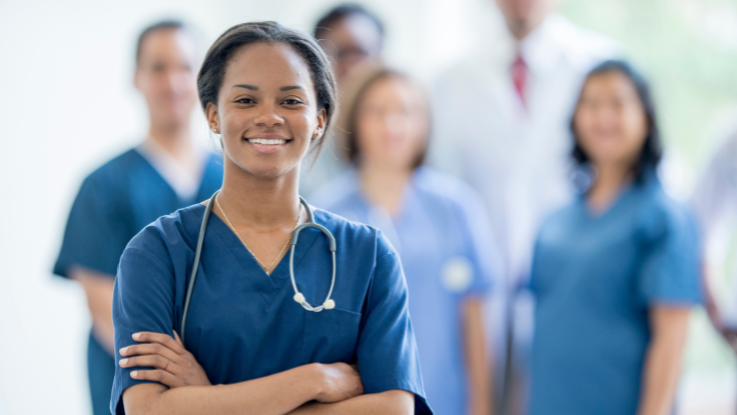 a group of nurses wearing blue scrubs