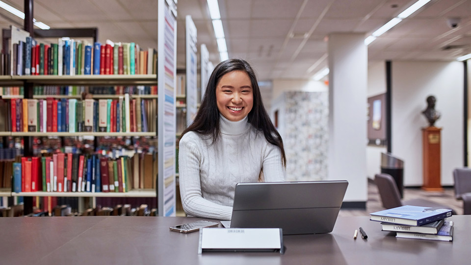 a student is in a library working