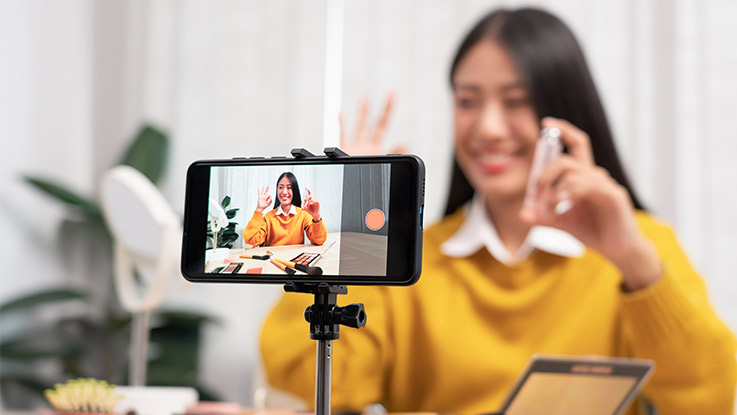 a girl who is recording content on her smart phone