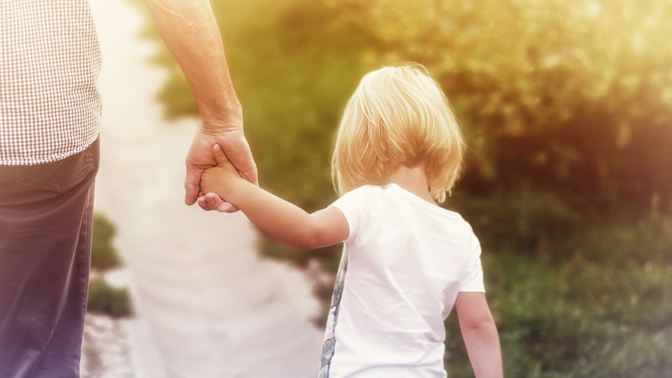Father holding his daughter's hand