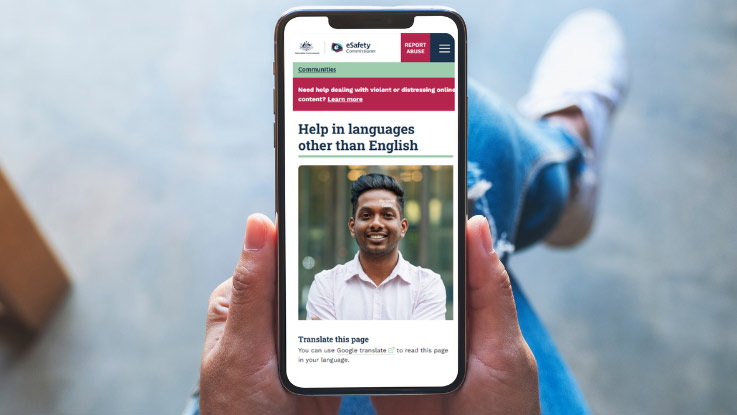 a person on their smartphone viewing the esafety translated resource page