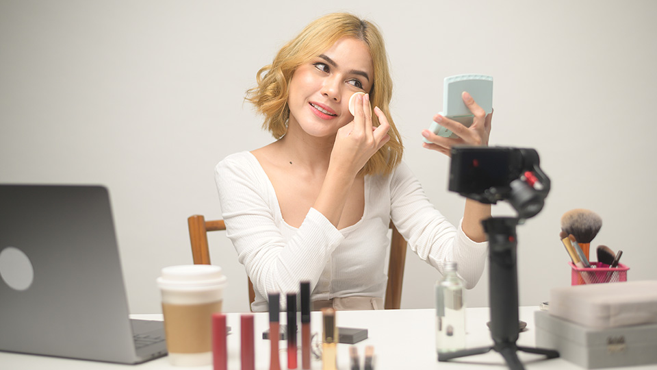 A young content creator making a makeup tutorial