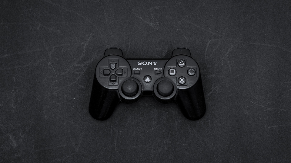 Sony Playstation Controller sitting on a dark surface