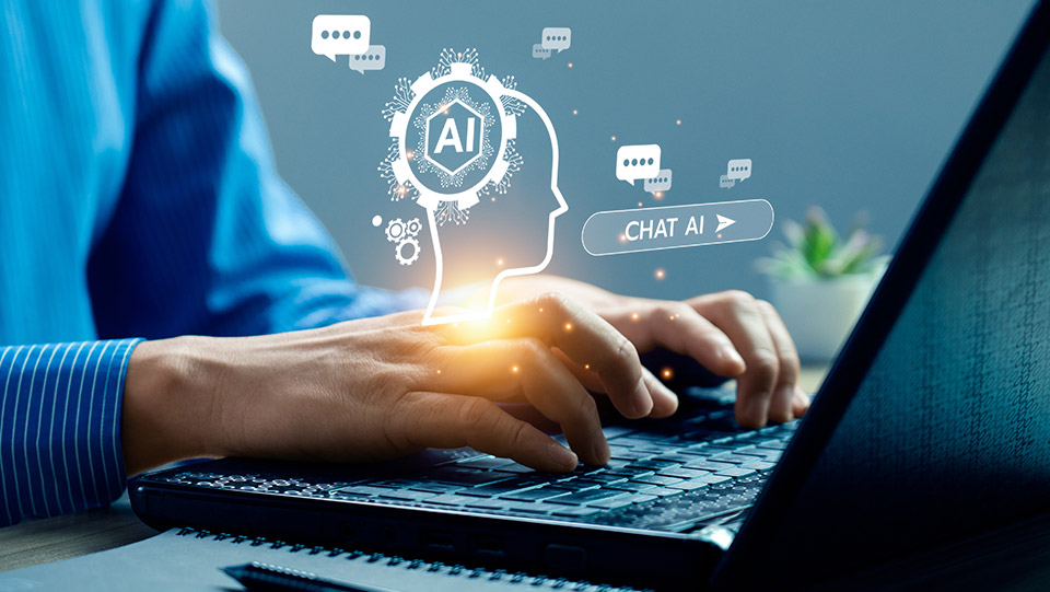 a person using a laptop with their hands on the keyboard