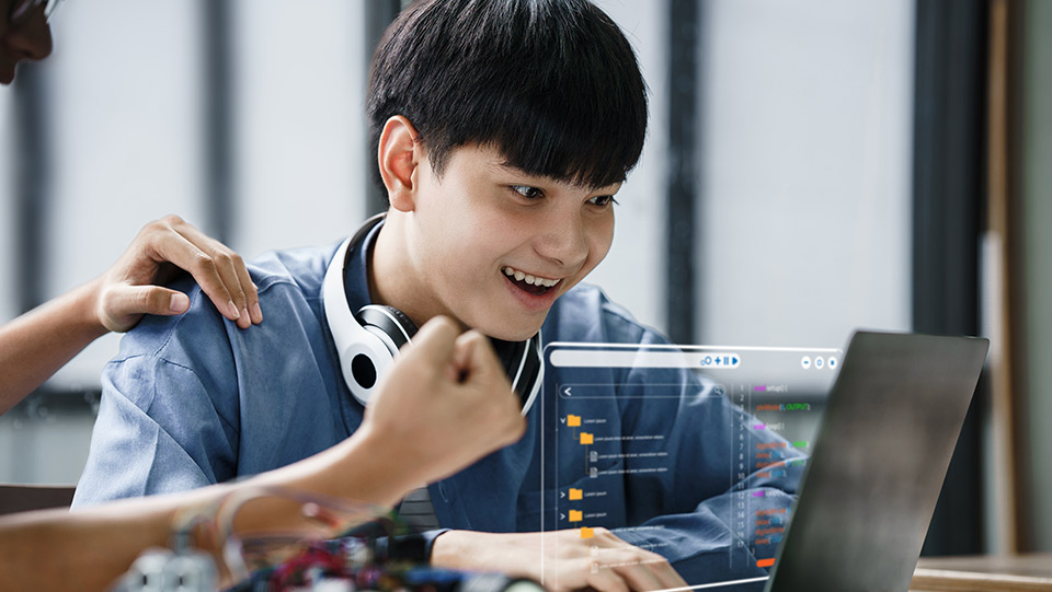 a student is on a laptop with a transparent screen that is hovering in front of the laptop screen