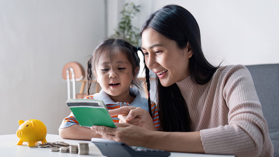 a mother is playing with numbers with her daughter in front of a couch
