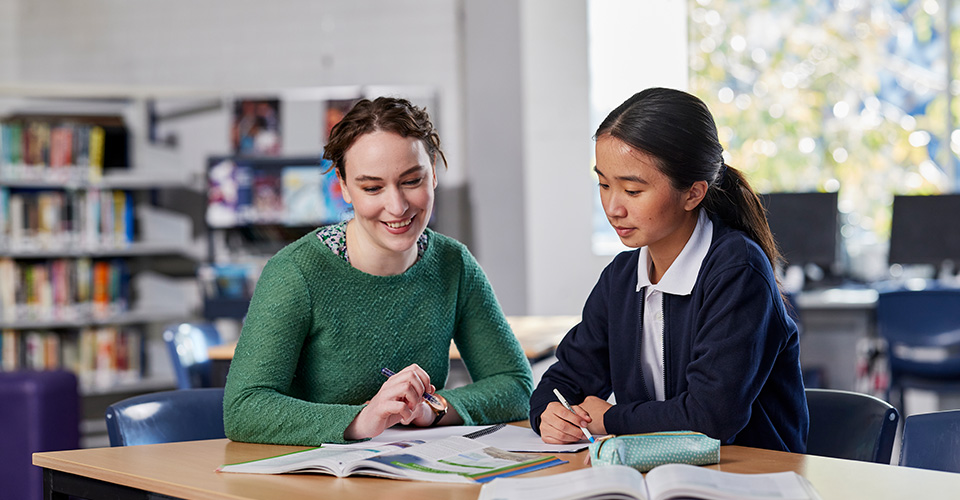 a tutor helping a high school student