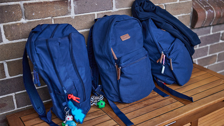 Three blue school bags