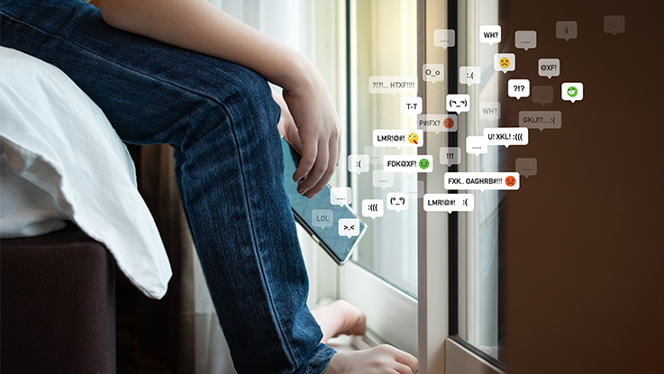 Hand holding a smartphone displaying social media and message icons.