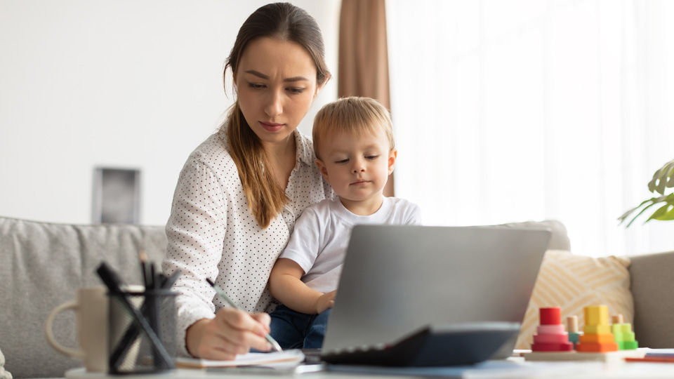 mum with baby looking at laptop