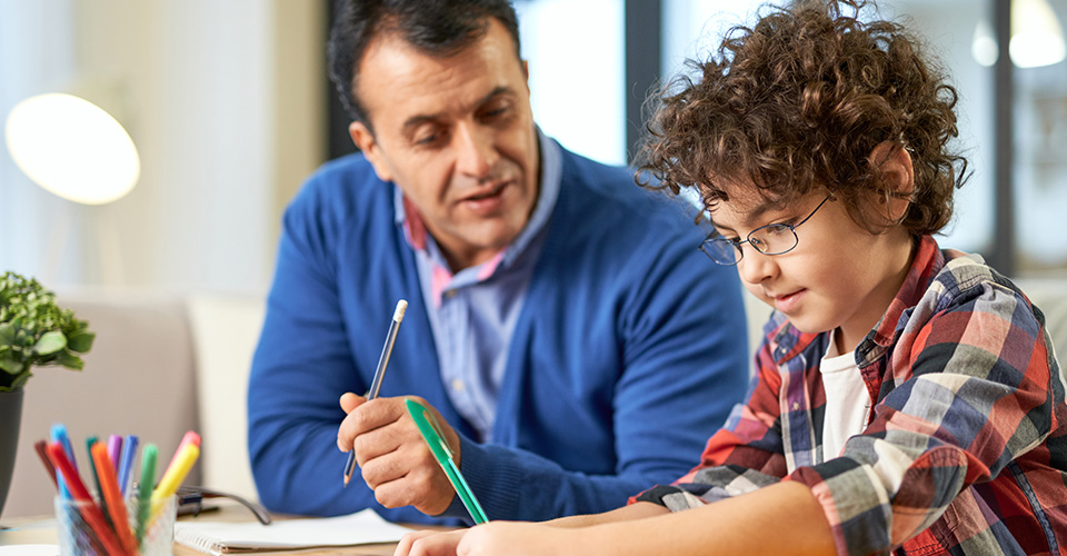a father helping his son with his homework