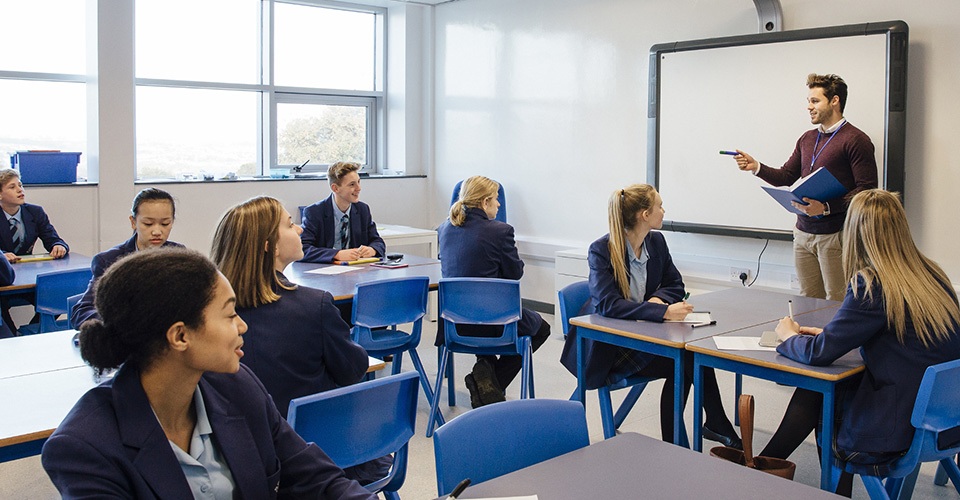 teacher in a classroom teaching his class