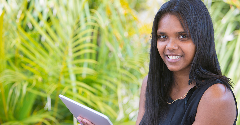 girl smiling while using her ipad