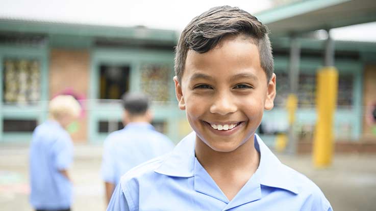 Smiling boy in school classroom