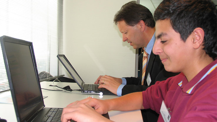 Andreas and Wael working on the computer