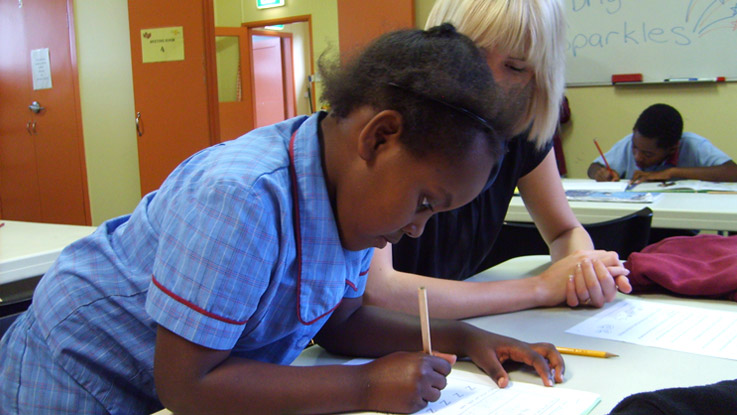 Girl writing at the Homework Club