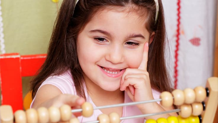 Girl learning to count using the abacus