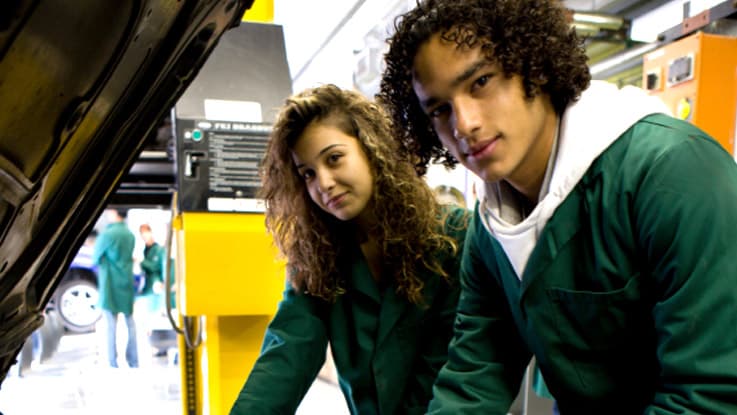 Two students doing work experience at a mechanic