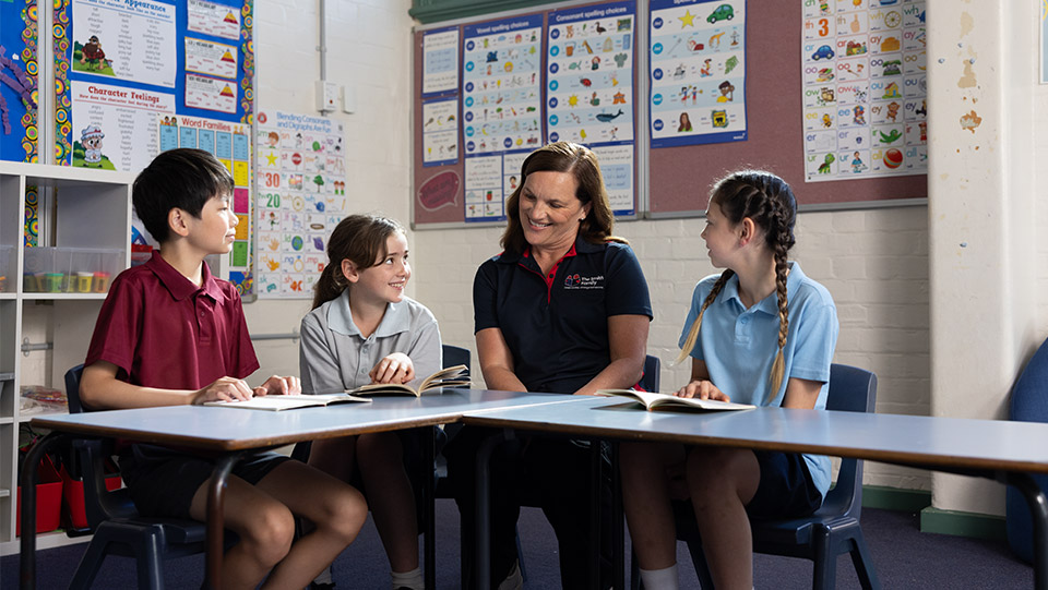 a smith family learning for life tutor with school students in the classroom