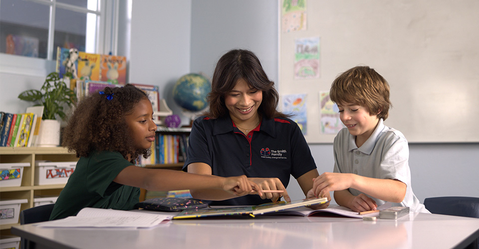 the smith family tutor supporting two students in the classroom