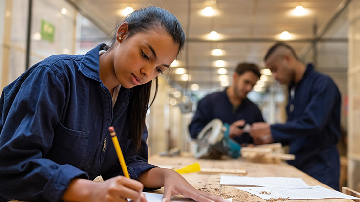 a young women working in a woodworking bench