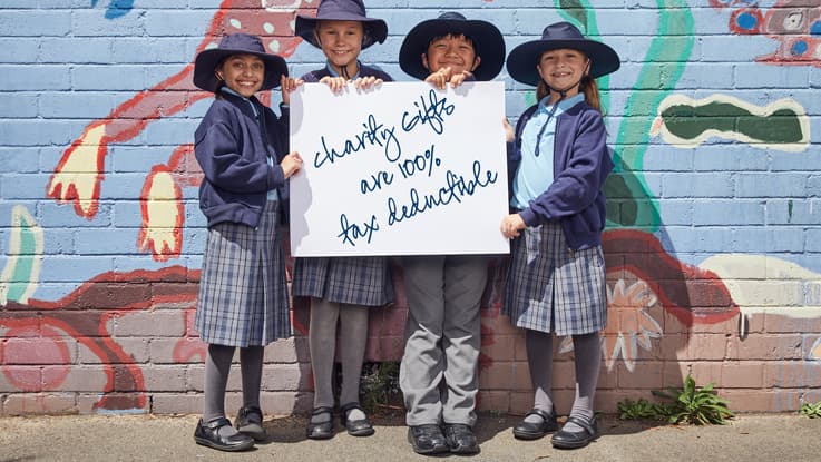 School kids holding a sign