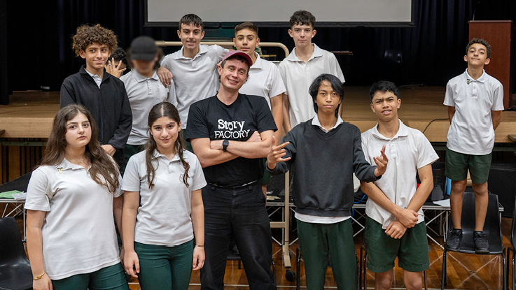 a group of high school students in their school hall with their teacher