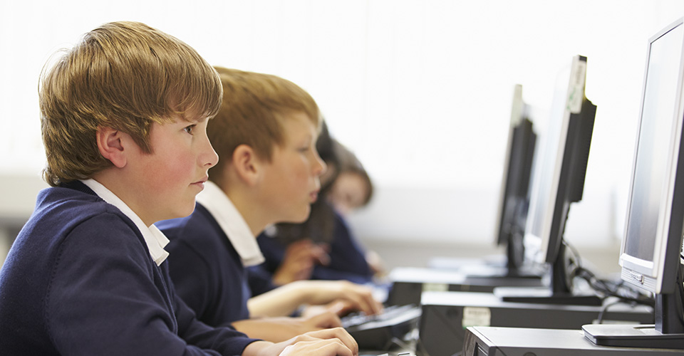 a school boy using a computer