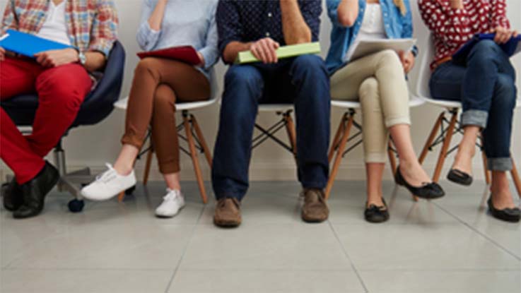 people-seated-in-chairs-legs