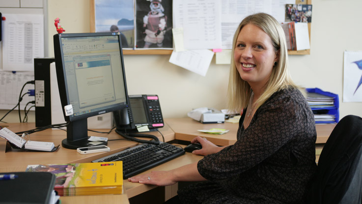 Sally sitting at desk