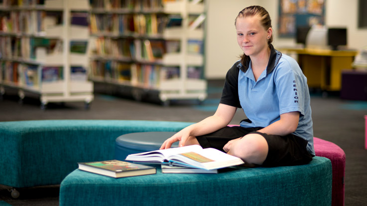 Crystal sitting in the library reading